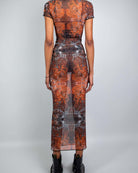 Back view of a model wearing a fitted Fossil Mesh Baby Tee Maxi Dress with cap sleeves and floor-length silhouette.
