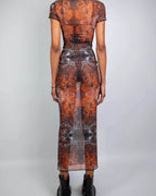 Back view of rave bodysuit style Fossil mesh maxi dress in orange rust tones for festival outfit