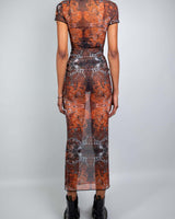 Back view of a model wearing a fitted Fossil Mesh Baby Tee Maxi Dress with cap sleeves and floor-length silhouette.