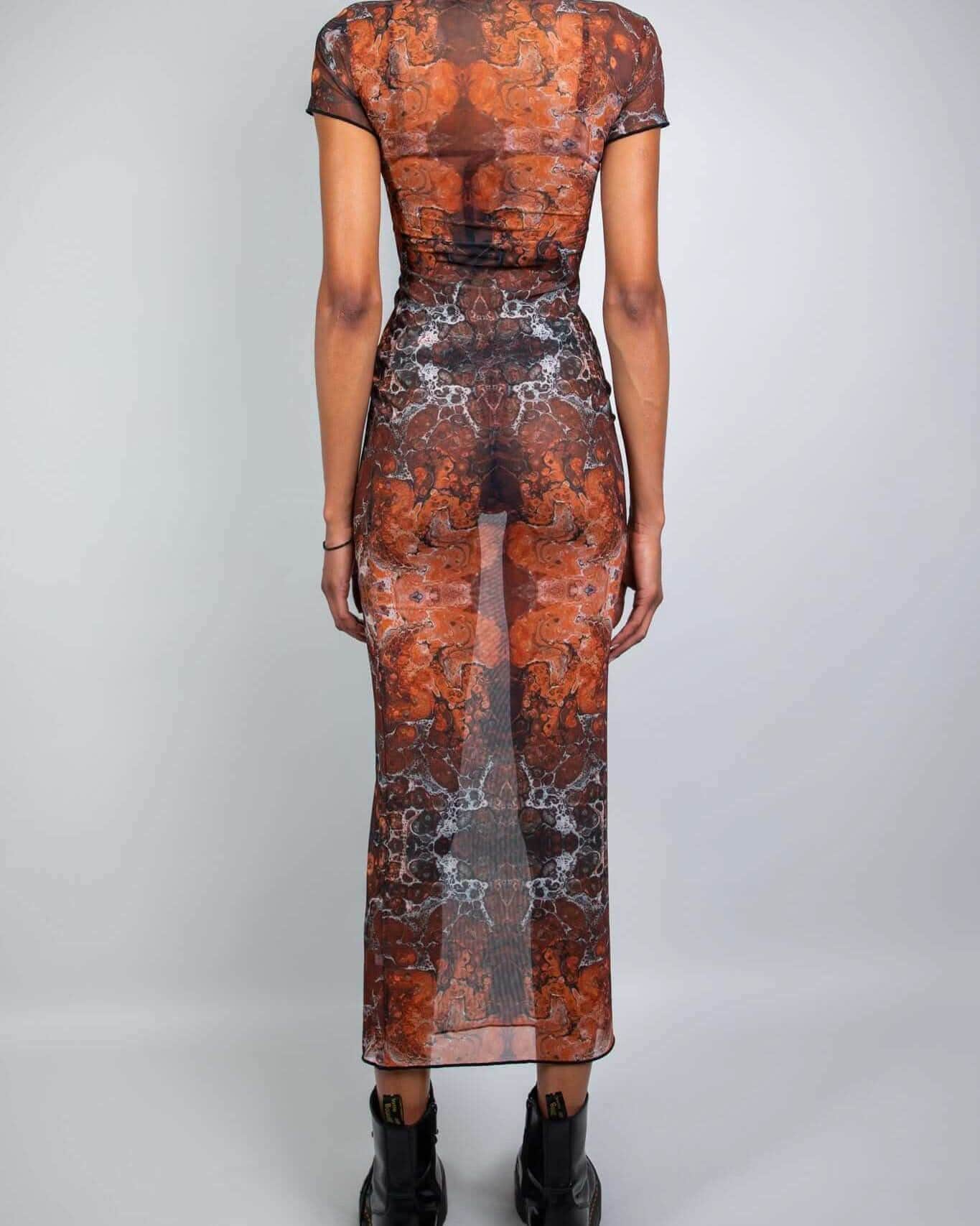 Back view of a model wearing a fitted Fossil Mesh Baby Tee Maxi Dress with cap sleeves and floor-length silhouette.