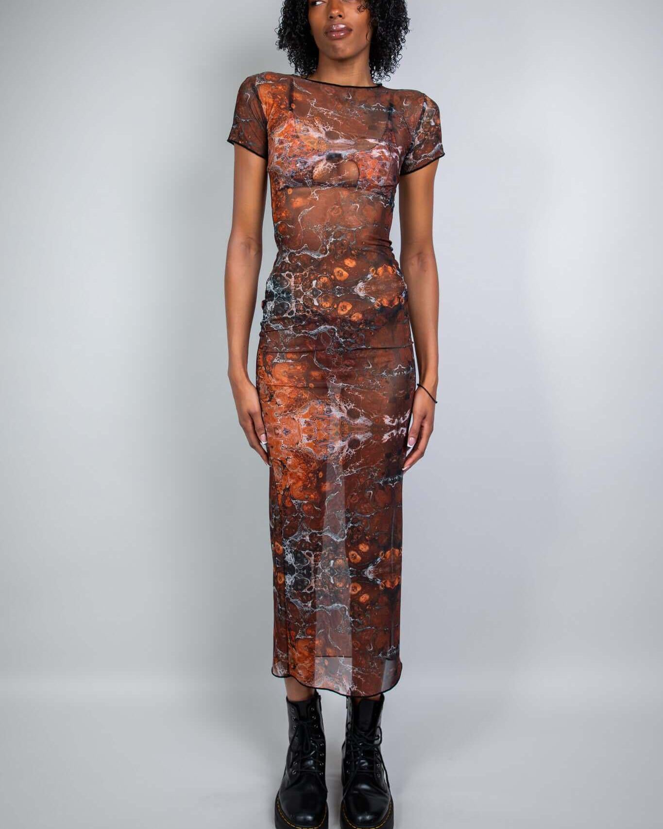 Model wearing the Fossil Mesh Baby Tee Maxi Dress, perfect for rave outfits, showcasing a fitted silhouette and breathable mesh design.