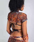 Back view of Fossil mesh rave top with marbled orange print and black tie straps for festival outfit styling