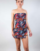 Angled pose in the Good Fortune Mesh Christina Dress, showcasing its form-fitting design and vibrant pattern.