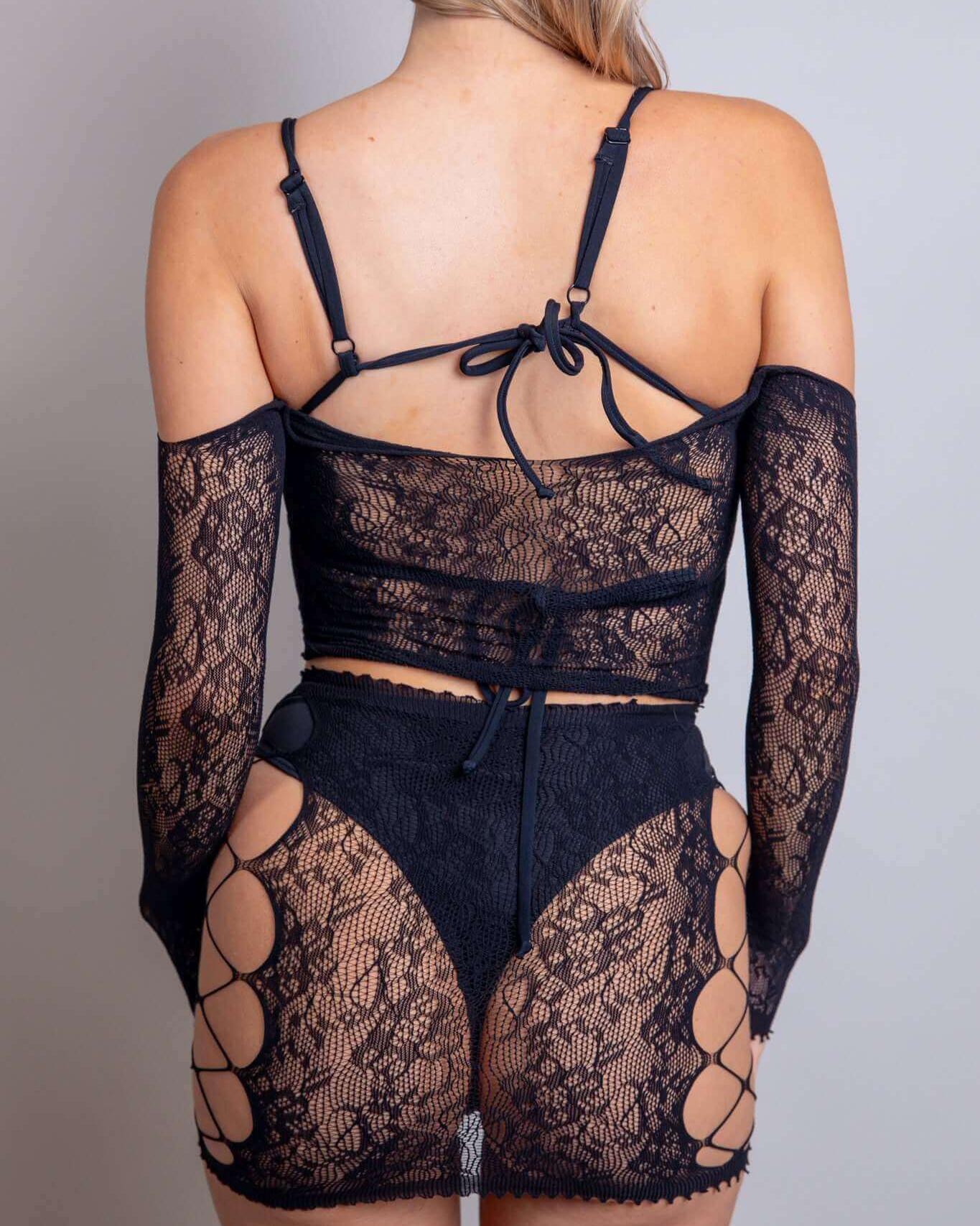 Model showcasing Gothic Glamour Lace Set with fishnet and lace details, perfect for rave outfits and sultry looks.