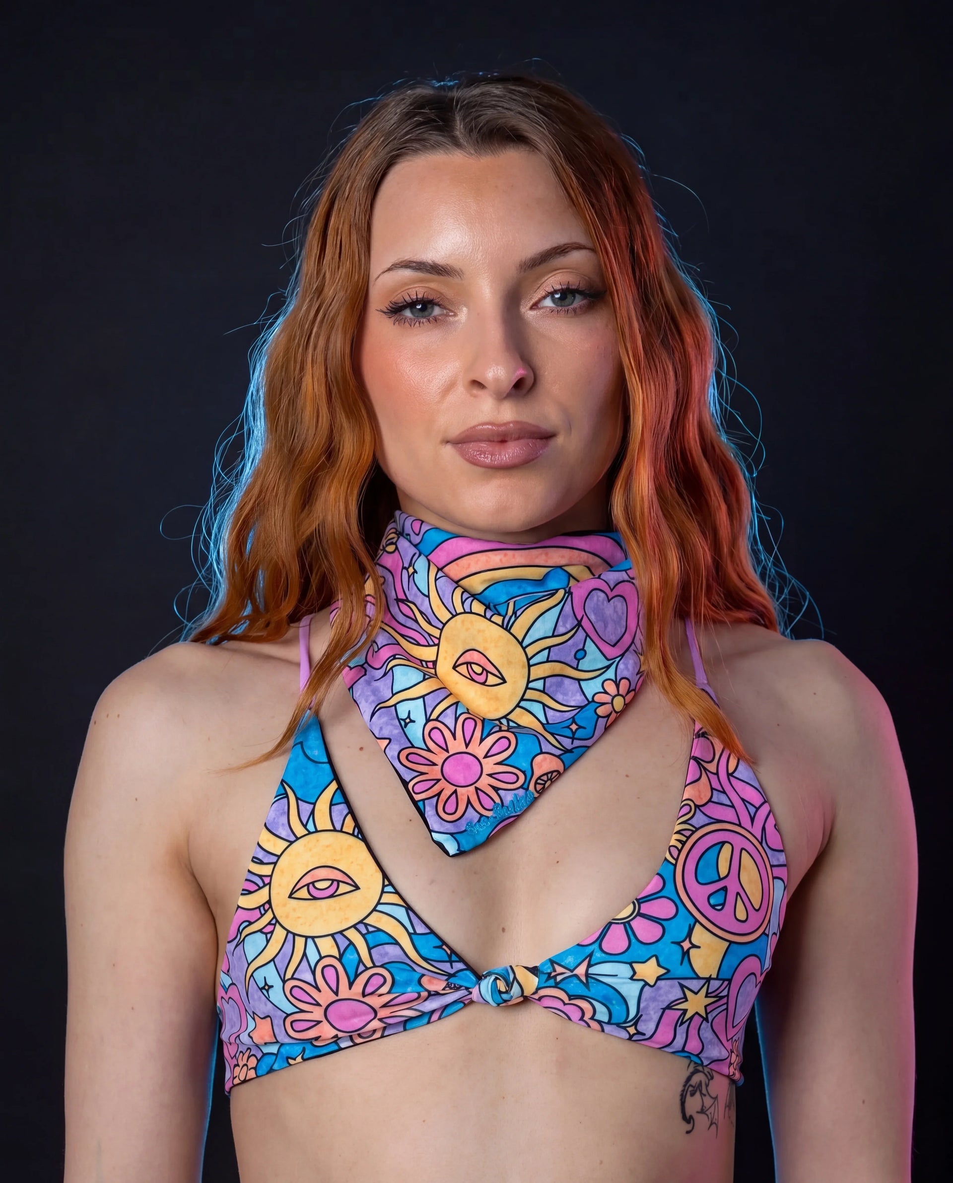 Groovy Bandana and matching top on a model, front view, featuring a vibrant multi-color rave pattern.