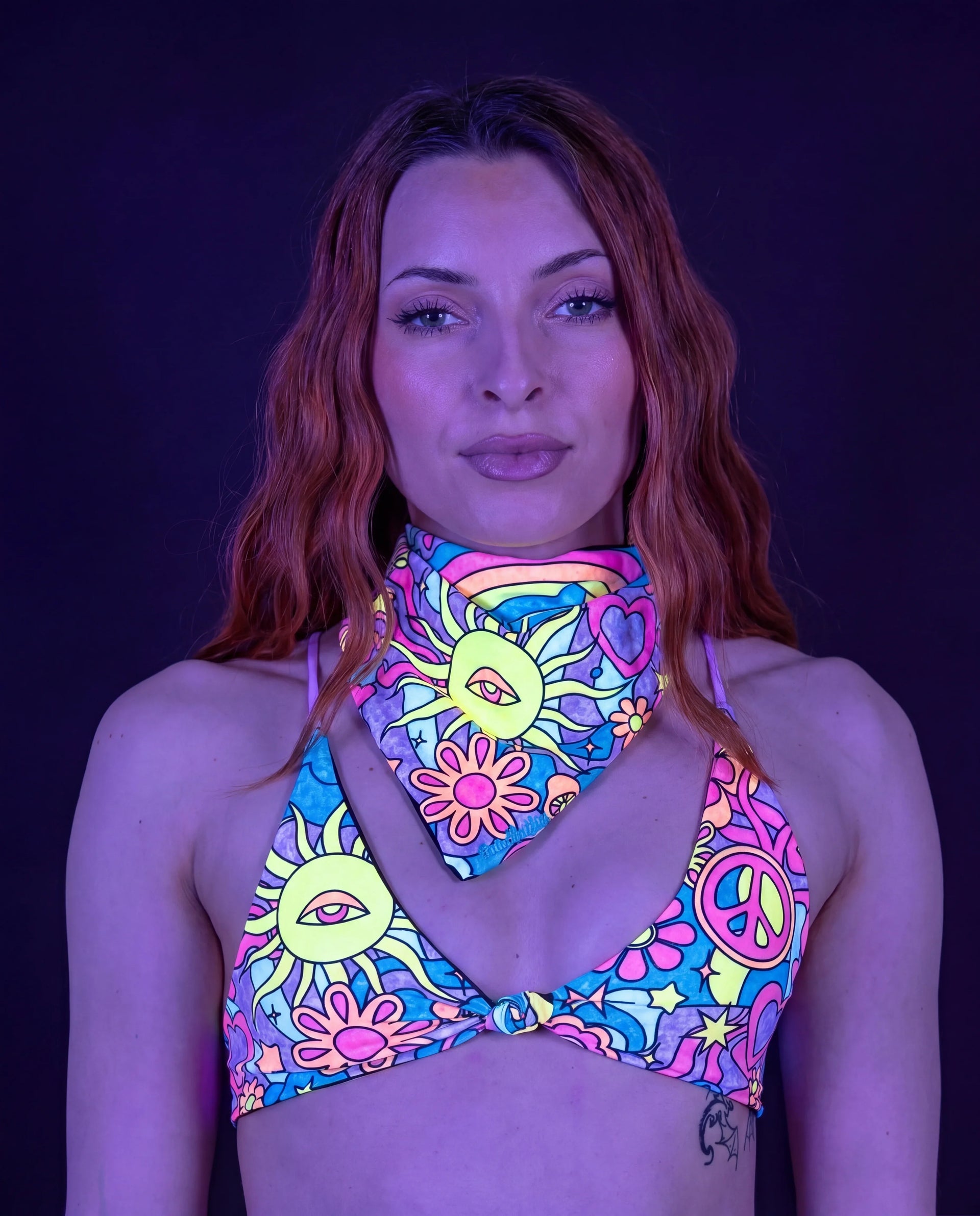 Groovy Bandana and matching top on a model, front view, featuring a vibrant multi-color rave pattern. — UV blacklight