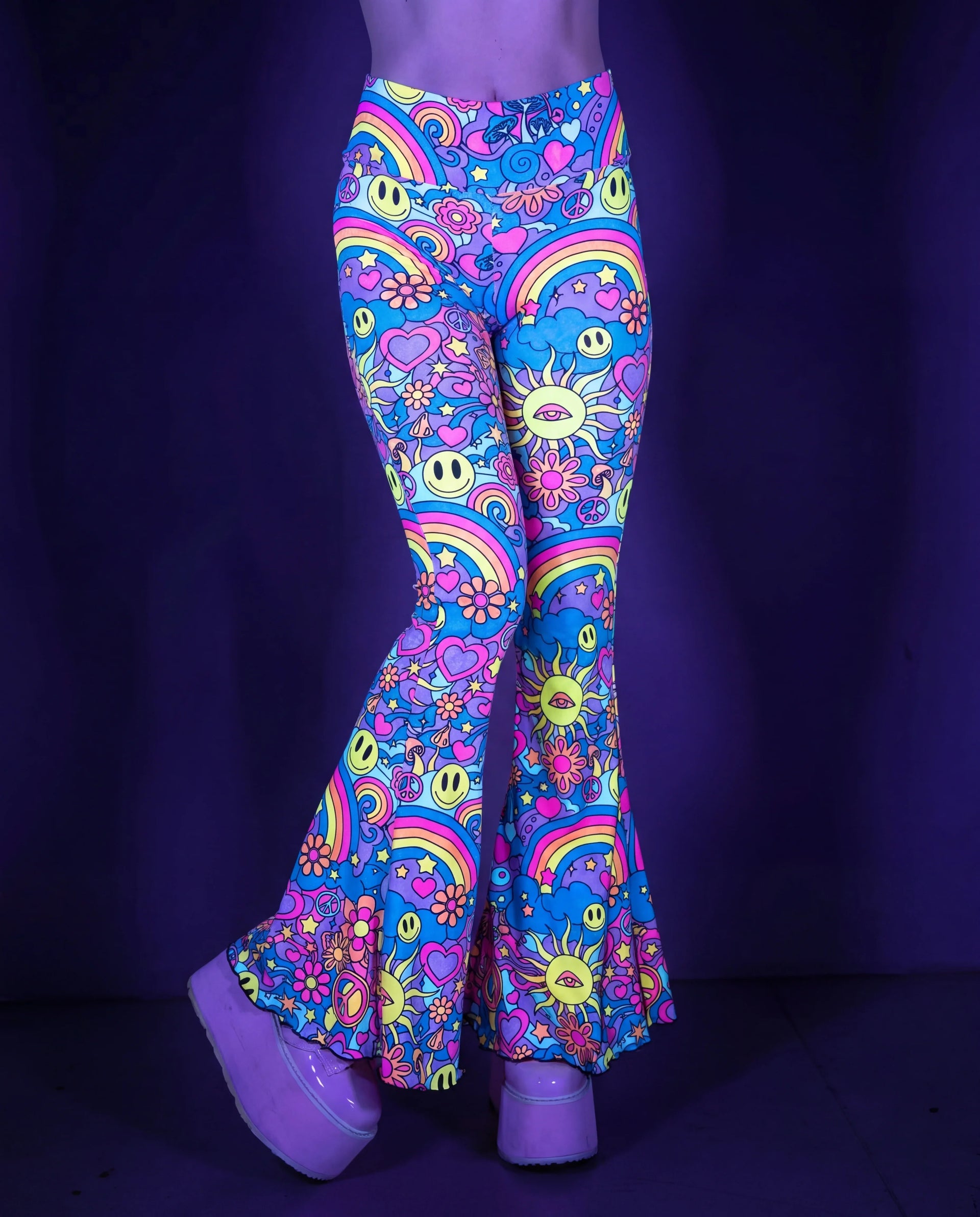 Groovy Bell Bottoms in a vibrant psychedelic pattern with smiley faces and rainbows, perfect for a rave festival. — UV blacklight