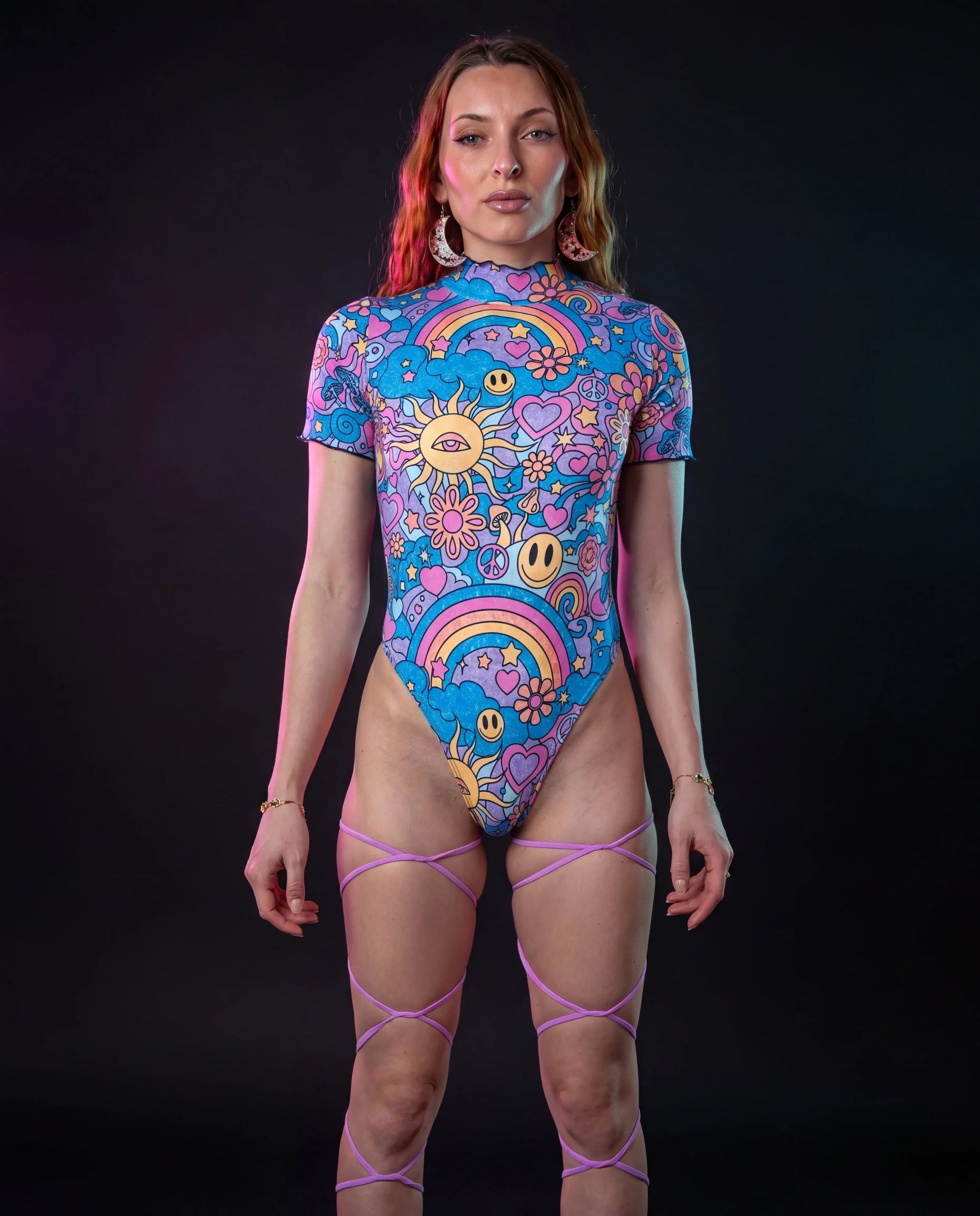 Groovy Wavy Baby Bodysuit front view, featuring a vibrant psychedelic pattern with smiley faces, mushrooms, and rainbows, perfect for rave festivals.