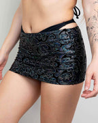 Black holographic Hellcat rave skirt with iridescent swirl pattern and side cinch drawstring for festival outfits