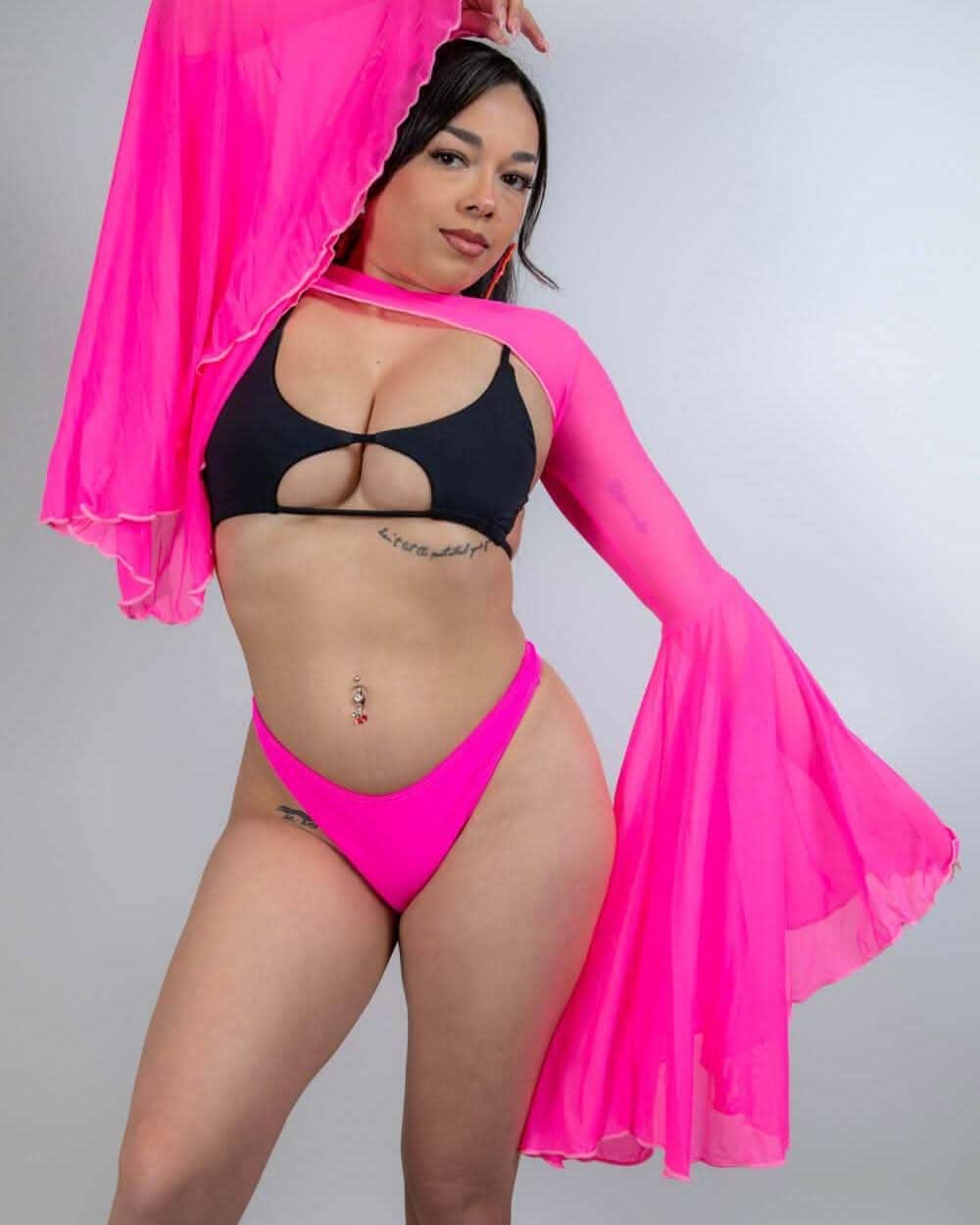 Model wearing hot pink mesh bell sleeves and a black bikini, perfect for rave outfits and rave clothing.