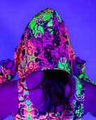 Reversible Intensity Assassin Hood featuring vibrant trippy UV print, perfect for rave outfits.