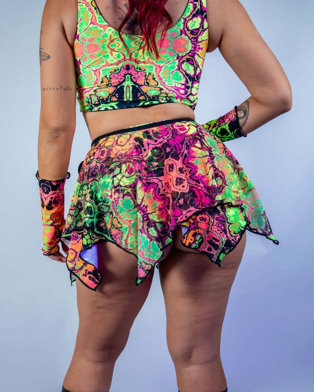 Model wearing a vibrant Intensity Fairy Skirt and matching top, perfect for rave outfits and carefree festival moments.