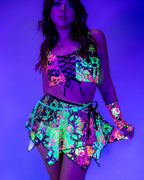 Intensity fairy rave skirt in neon psychedelic print with handkerchief layers under blacklight festival lighting