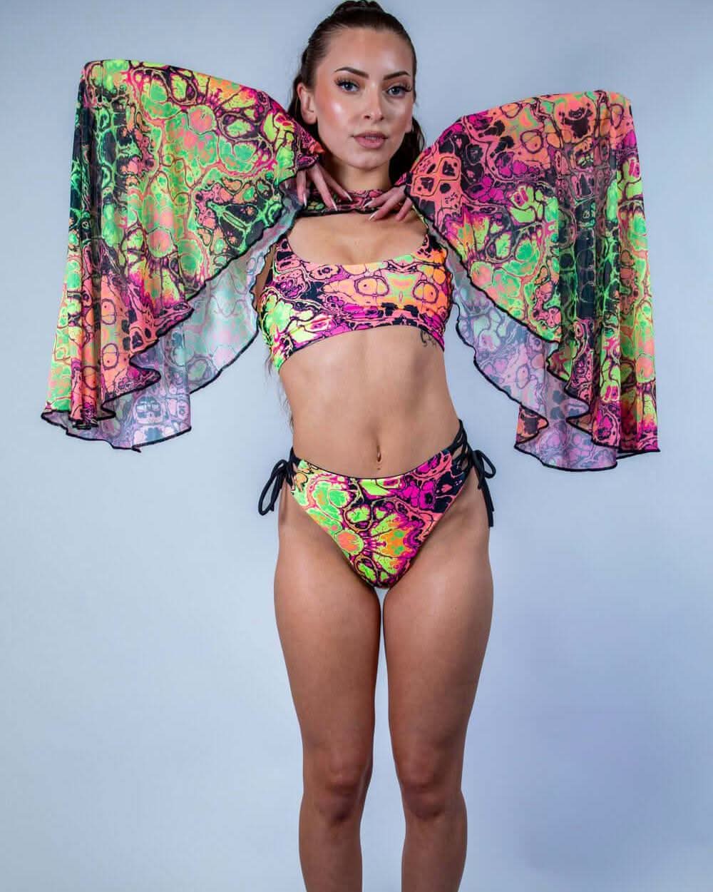 Model wearing colorful Intensity Mesh Bell Sleeves with matching rave outfit, perfect for festivals and parties.