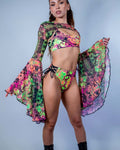 Model showcasing Intensity Mesh Bell Sleeves with matching rave outfit in vibrant UV reactive colors.