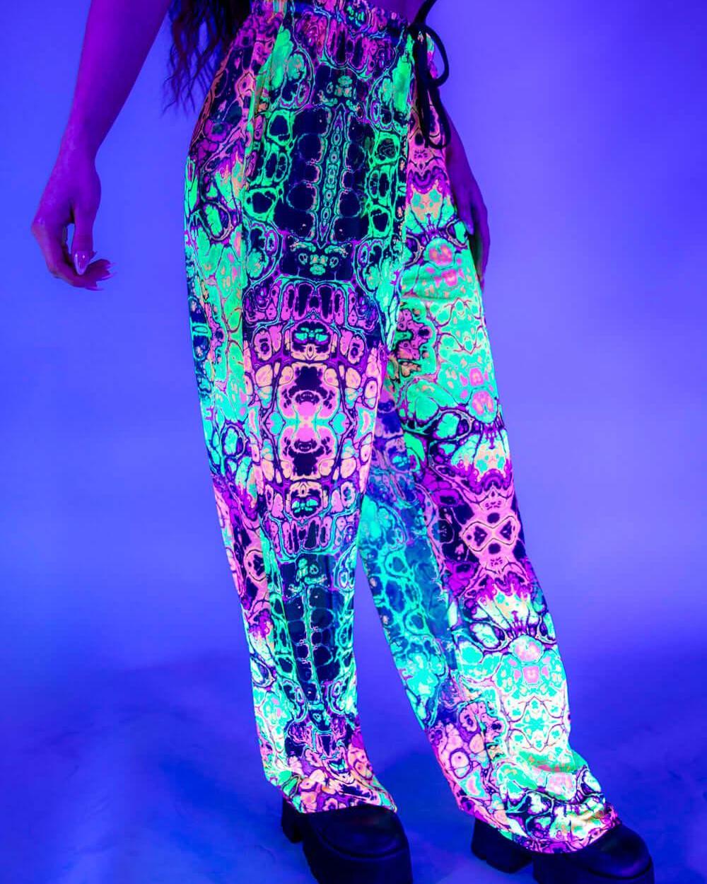 Funky rainbow mesh rave pants with a loose fit and UV-reactive design, perfect for festivals and dance events.