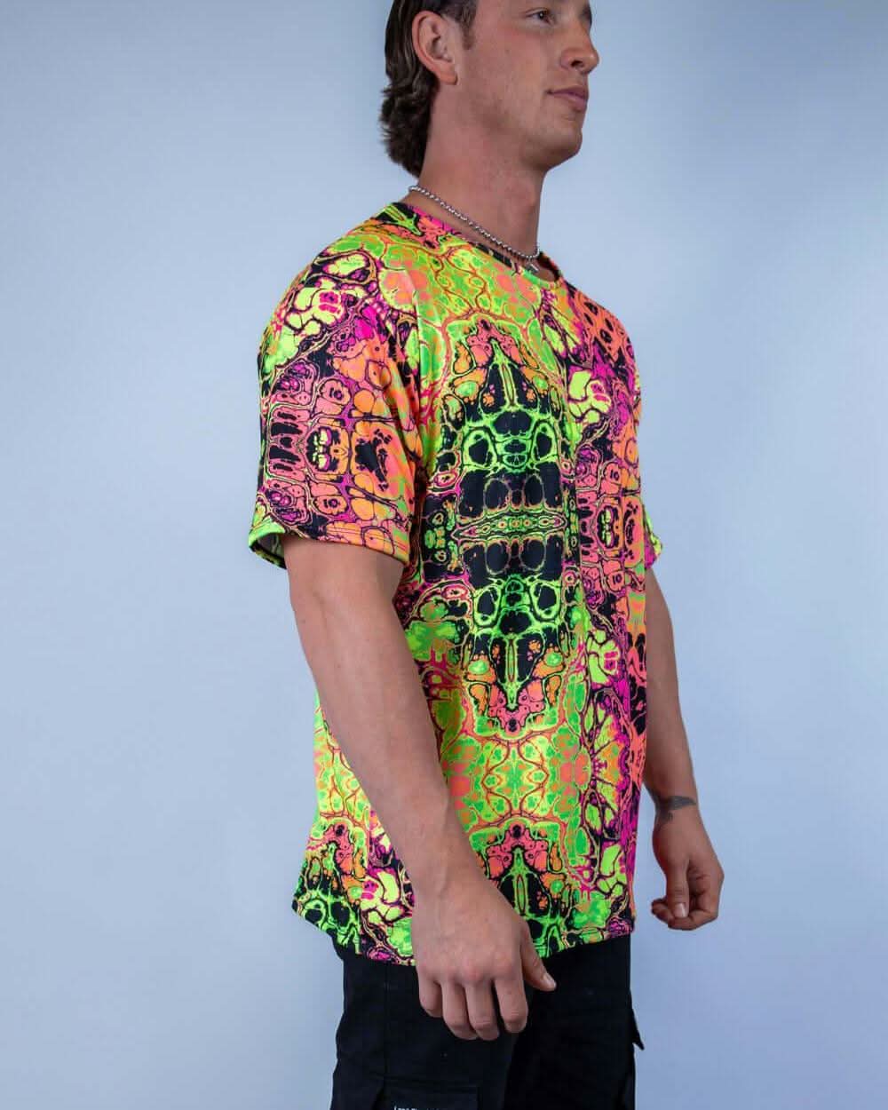 Man wearing a vibrant Intensity Oversized Softee t-shirt, featuring a colorful UV reactive print, ideal for rave outfits.