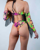 Model wearing the Intensity Twist Bodysuit with Fringe, showcasing vibrant colors and sexy high waist thong design.