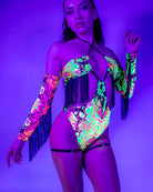 Model wearing Intensity Twist Bodysuit with fringe in UV light, showcasing bold colors perfect for rave outfits.