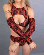 Model wearing red Labyrinth rave arm sleeves with matching bodysuit in geometric pattern pose