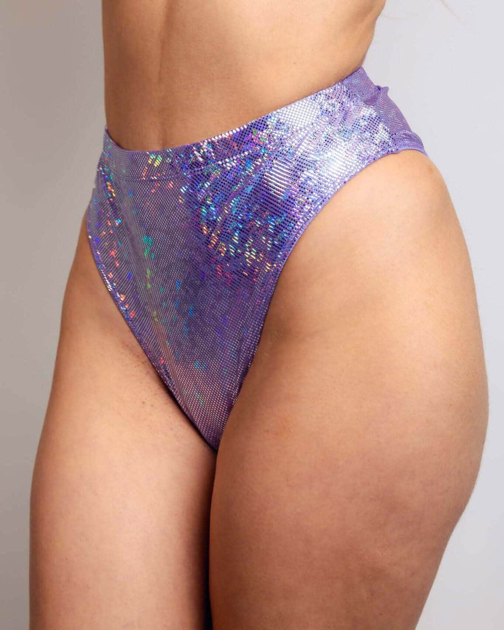 High-waisted lavender Brazilian bottoms featuring sparkly holographic design, perfect for rave outfits.