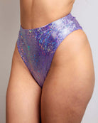 High-waisted lavender Brazilian bottoms featuring sparkly holographic design, perfect for rave outfits.