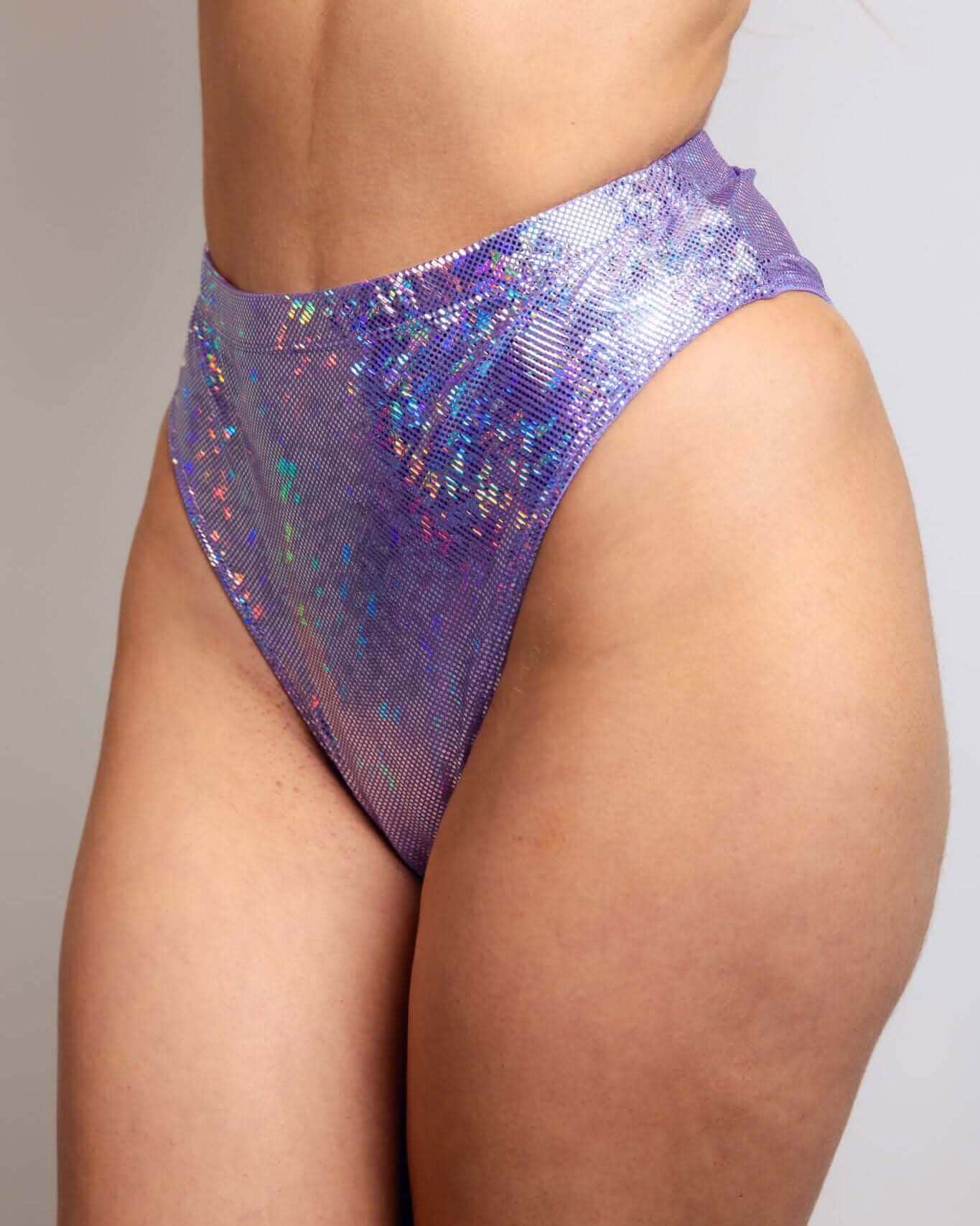 High-waisted lavender Brazilian bottoms featuring sparkly holographic design, perfect for rave outfits.