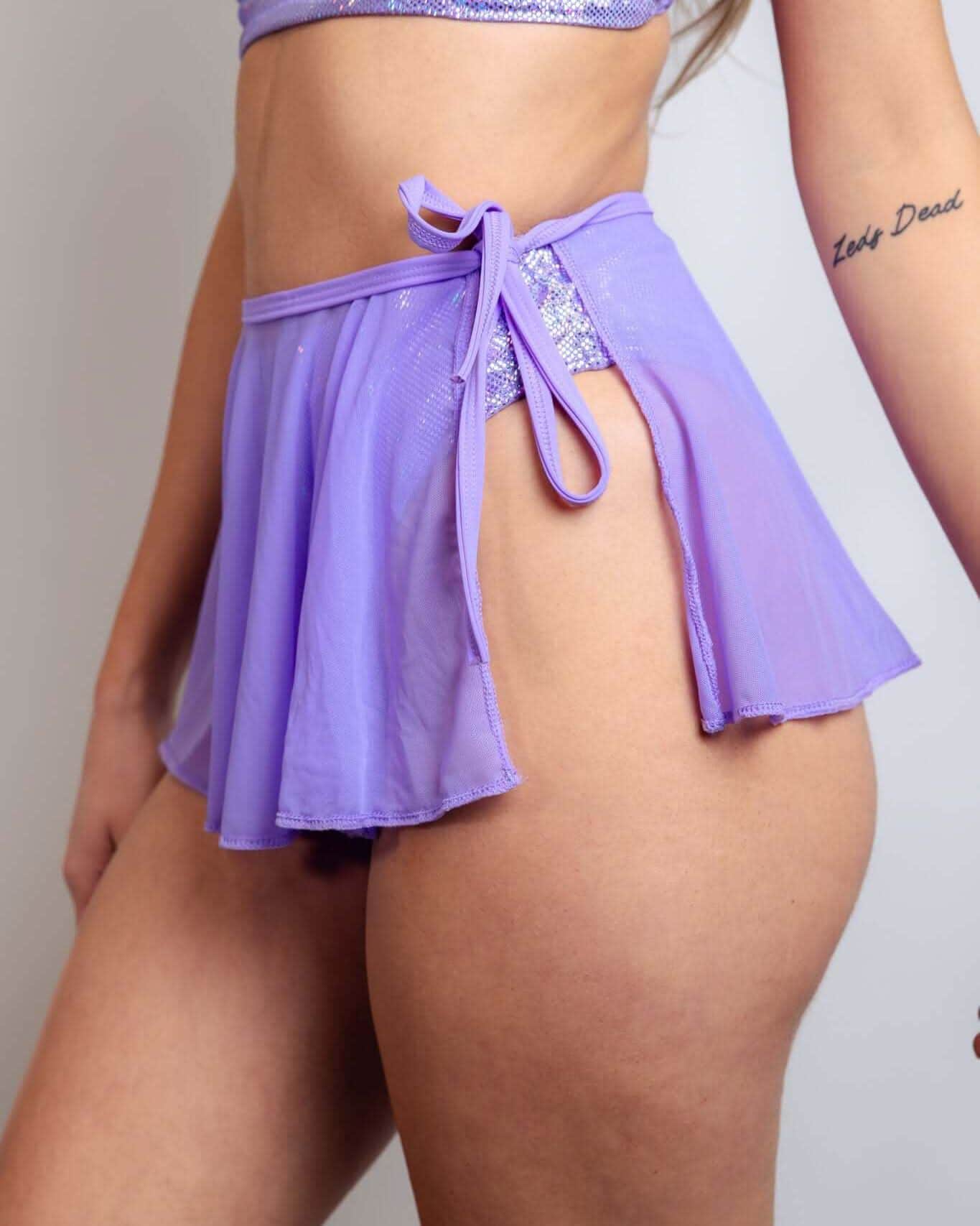 Lavender mesh swirl rave skirt with tie detail modeled from front showing purple festival outfit styling