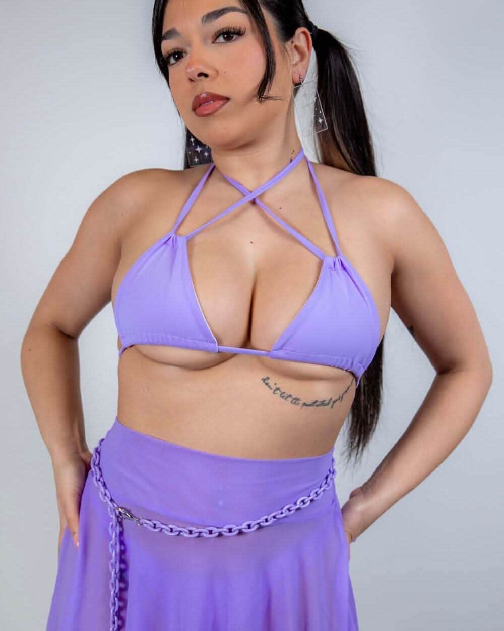 Model wearing a lavender strappy bikini top, perfect for rave outfits and beach days, showcasing a confident and stylish look.