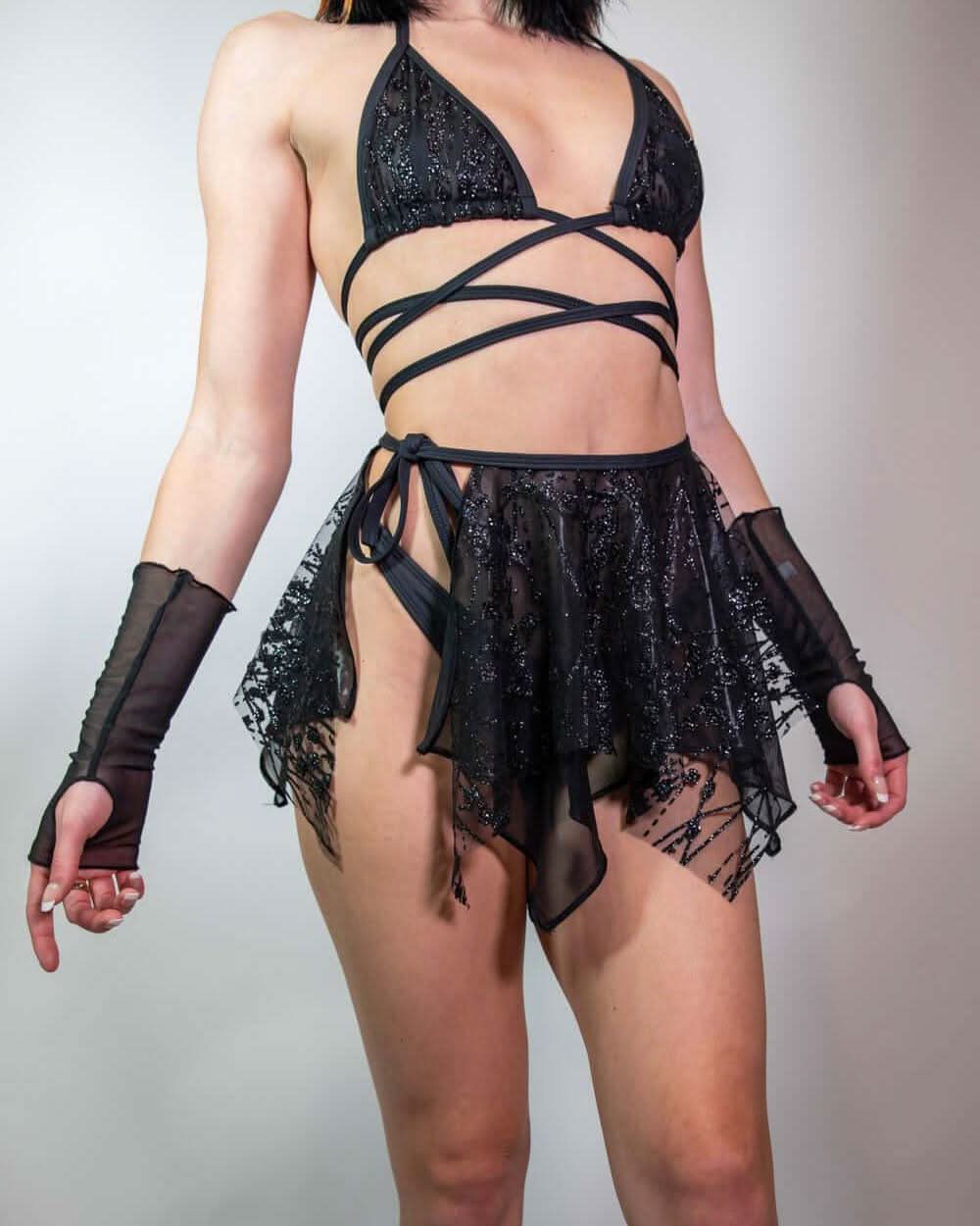 Model in the Lilith Wrap Bikini Top, captured in motion to highlight its wrap-around straps and bold festival look.