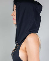 Side view of a woman wearing a matte black assassin hood with chain, perfect for rave outfits and festival protection.