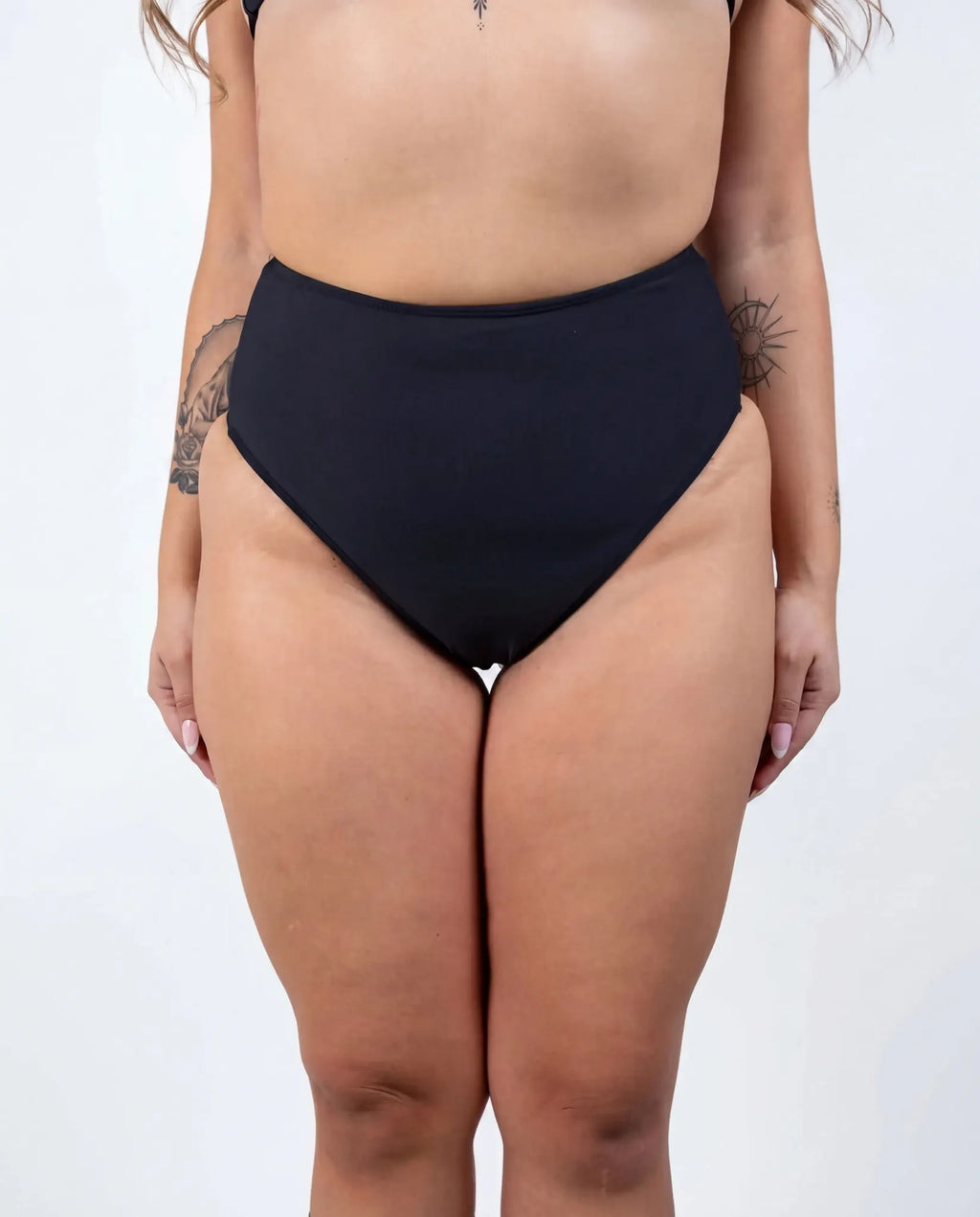 Matte black high waisted rave pants bikini bottoms front view festival outfit modeling shot