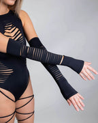 Model wearing matte black slit rave arm sleeves with horizontal cutouts in festival outfit pose