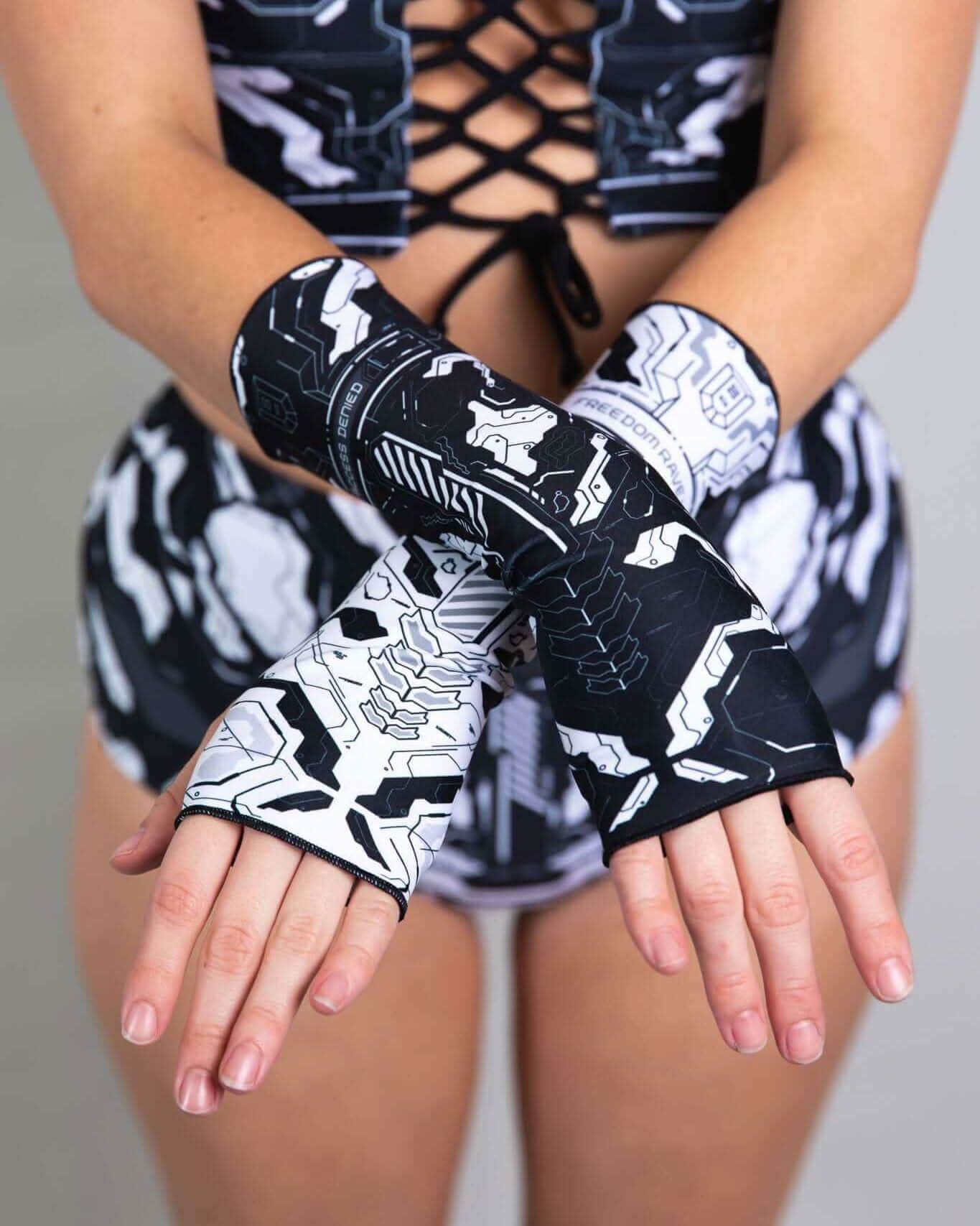 Model showcasing FRW exclusive Mechanoid Gloves in black and white, perfect for rave outfits and festival wear.
