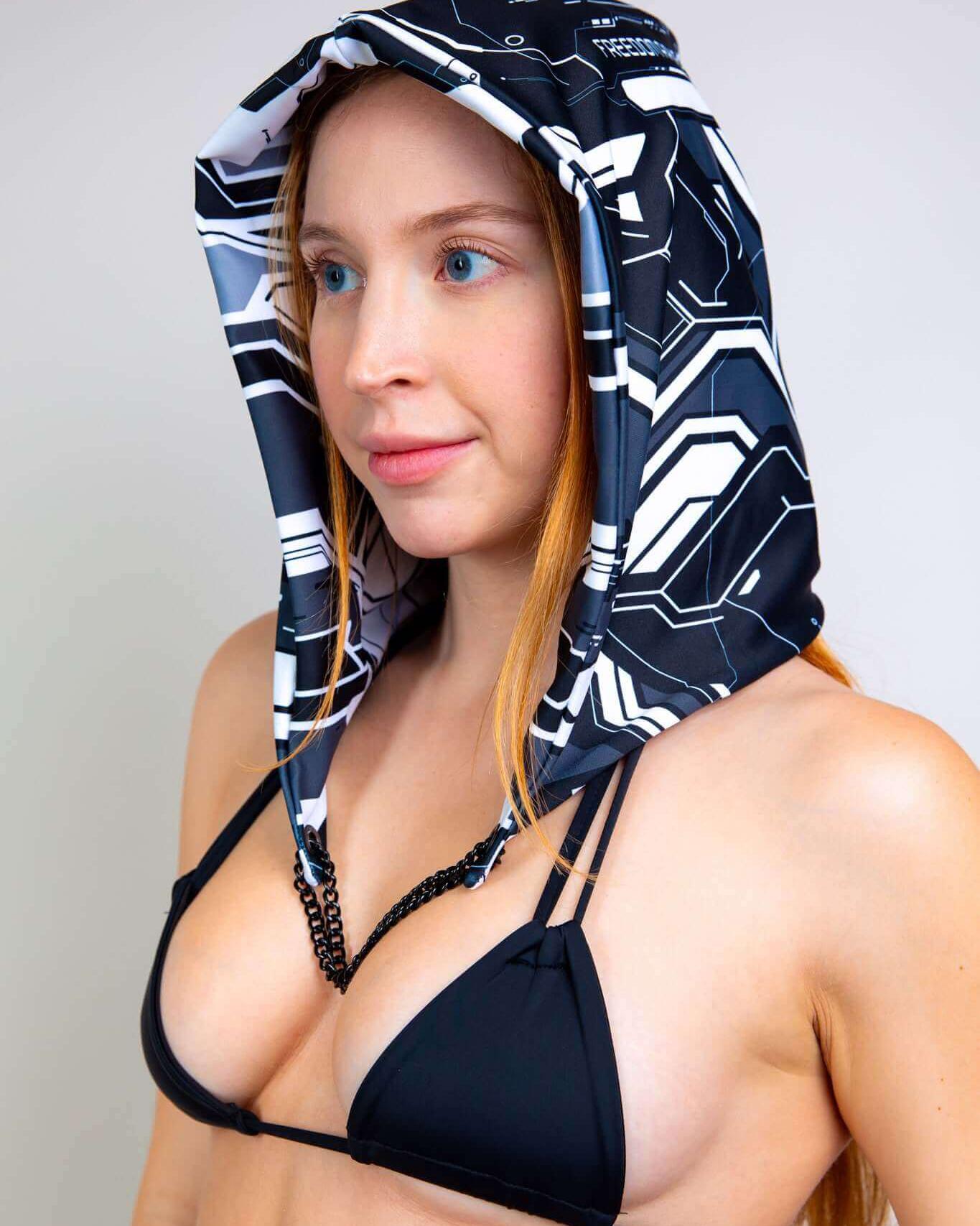 Woman wearing Mechanoid Reversible Hood with chain, ideal for rave outfits and festival accessories.
