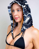 Woman wearing Mechanoid Reversible Hood with chain, ideal for rave outfits and festival accessories.
