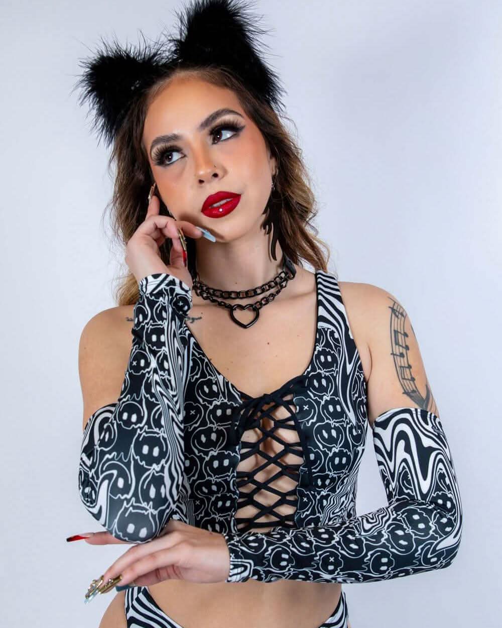 Model posing casually in Meltdown Arm Sleeves with one hand raised, emphasizing the soft, stretchy fit and festival-ready style.