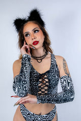 Model posing casually in Meltdown Arm Sleeves with one hand raised, emphasizing the soft, stretchy fit and festival-ready style.