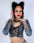 Model wearing Meltdown Arm Sleeves in front-facing pose with hands near face, showcasing the trippy melty smiley print.