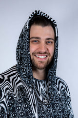 Close-up of the Meltdown Assassin Hood with the model smiling, highlighting the trippy pattern and snug hood fit.