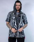 Model wearing the Meltdown Assassin Hood in full front view, holding the edges of the hood to show off the melty smiley print.