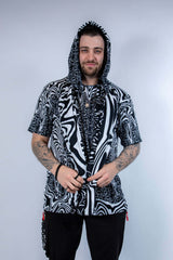 Model wearing the Meltdown Assassin Hood in full front view, holding the edges of the hood to show off the melty smiley print.