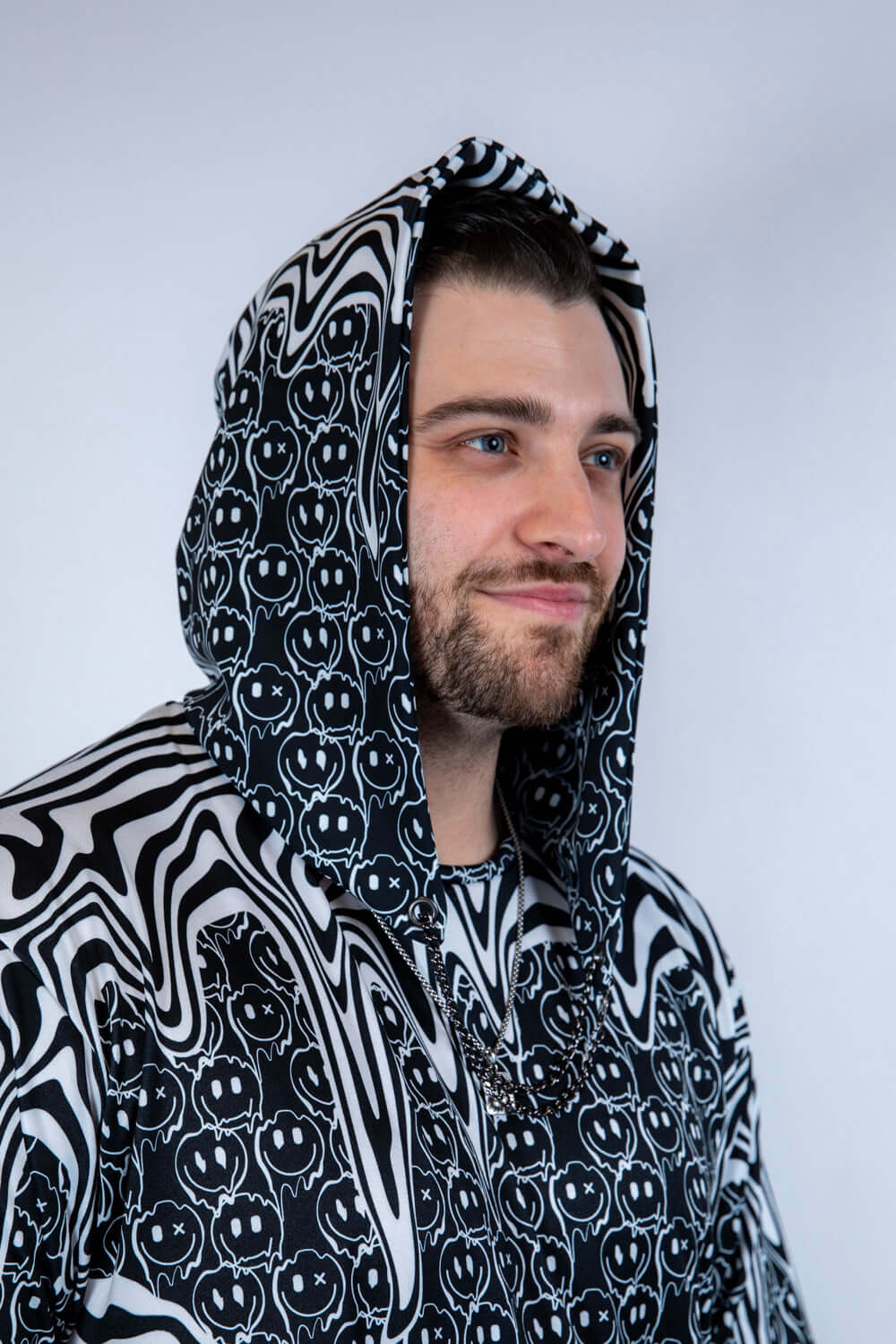 Side profile of the Meltdown Assassin Hood, showing off the curved hem and melty design with a relaxed smile.