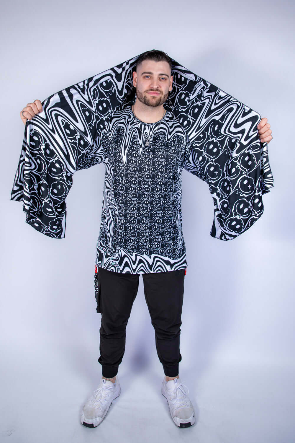 Model wearing the Meltdown Festival Scarf with arms outstretched, showcasing the full melty smiley design and lightweight summer fit.