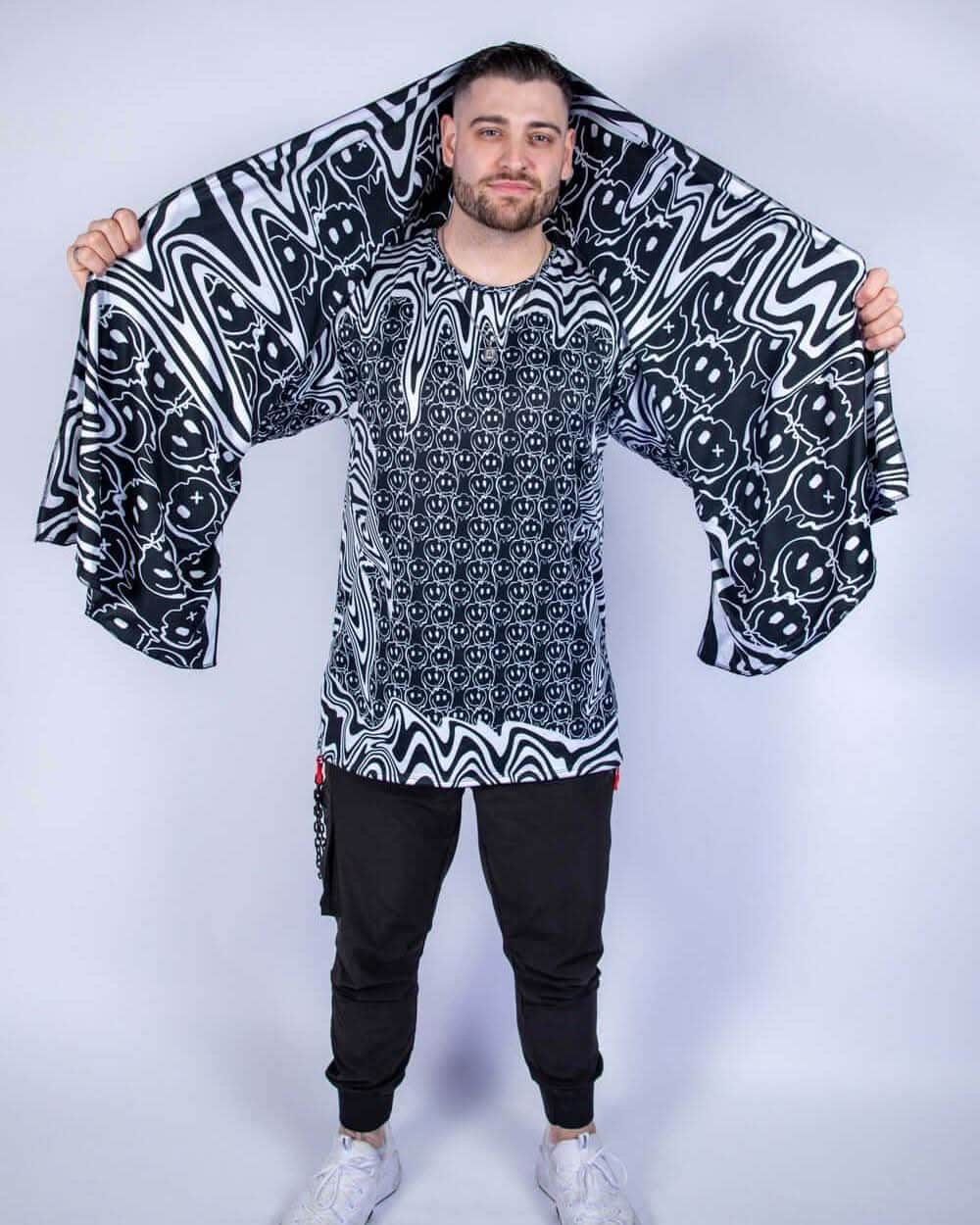 Model wearing the Meltdown Festival Scarf with arms outstretched, showcasing the full melty smiley design and lightweight summer fit.