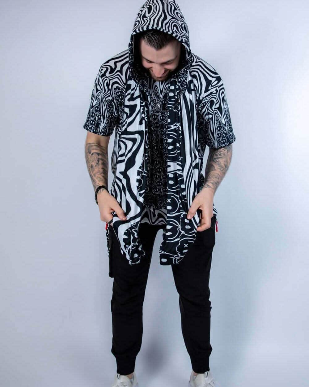 Model standing with the Meltdown Festival Scarf draped and hooded, showcasing a relaxed festival look.