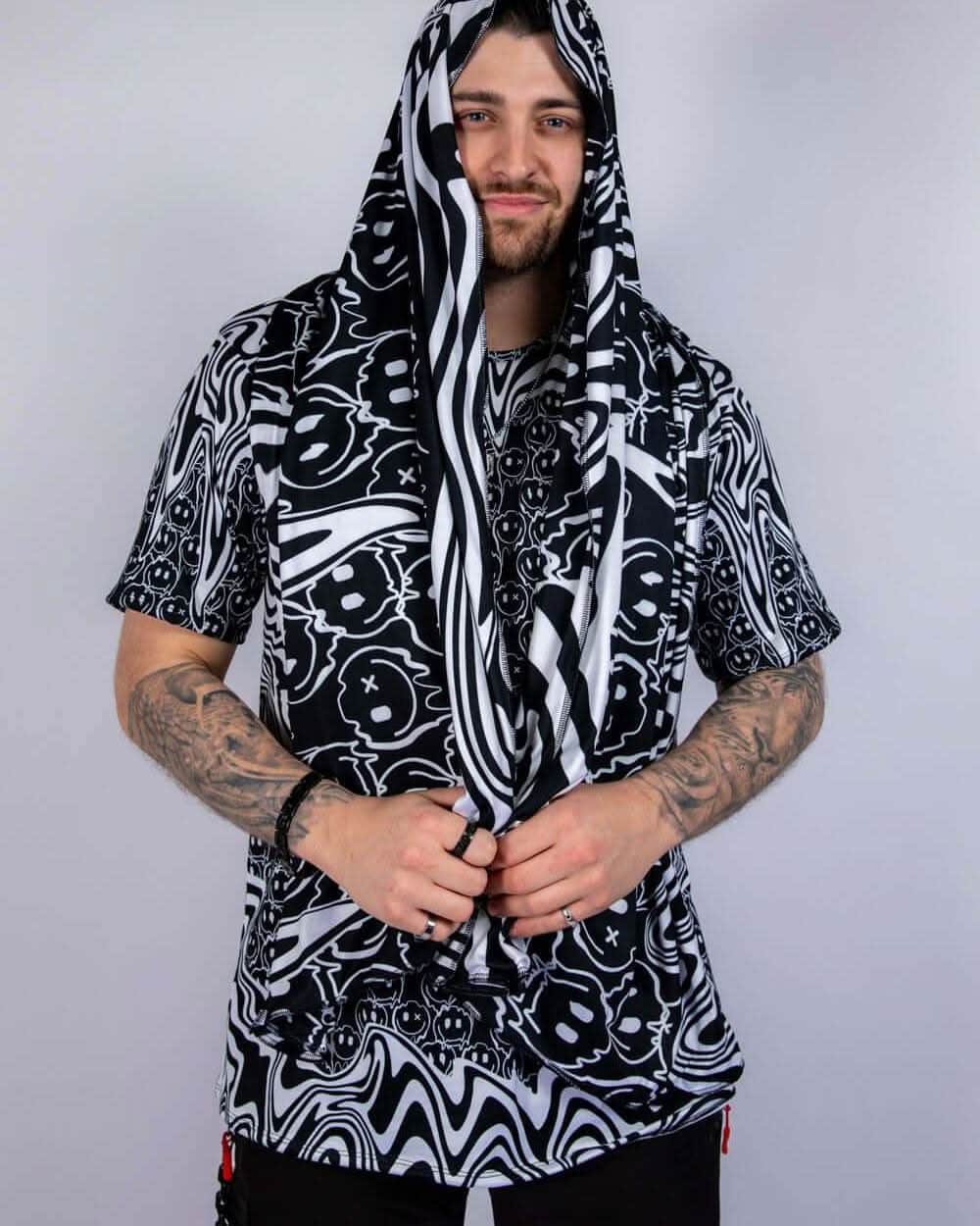 Model wearing the scarf draped with hood style, showing the soft texture and vibrant melty print details.