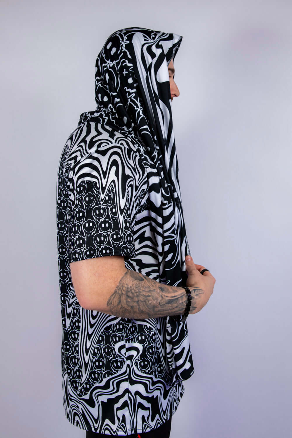 Side profile of the scarf worn hooded, highlighting its flowy fit and unique rave-ready styling options.