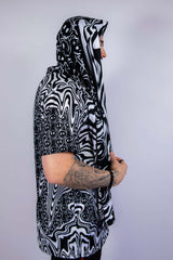 Side profile of the scarf worn hooded, highlighting its flowy fit and unique rave-ready styling options.