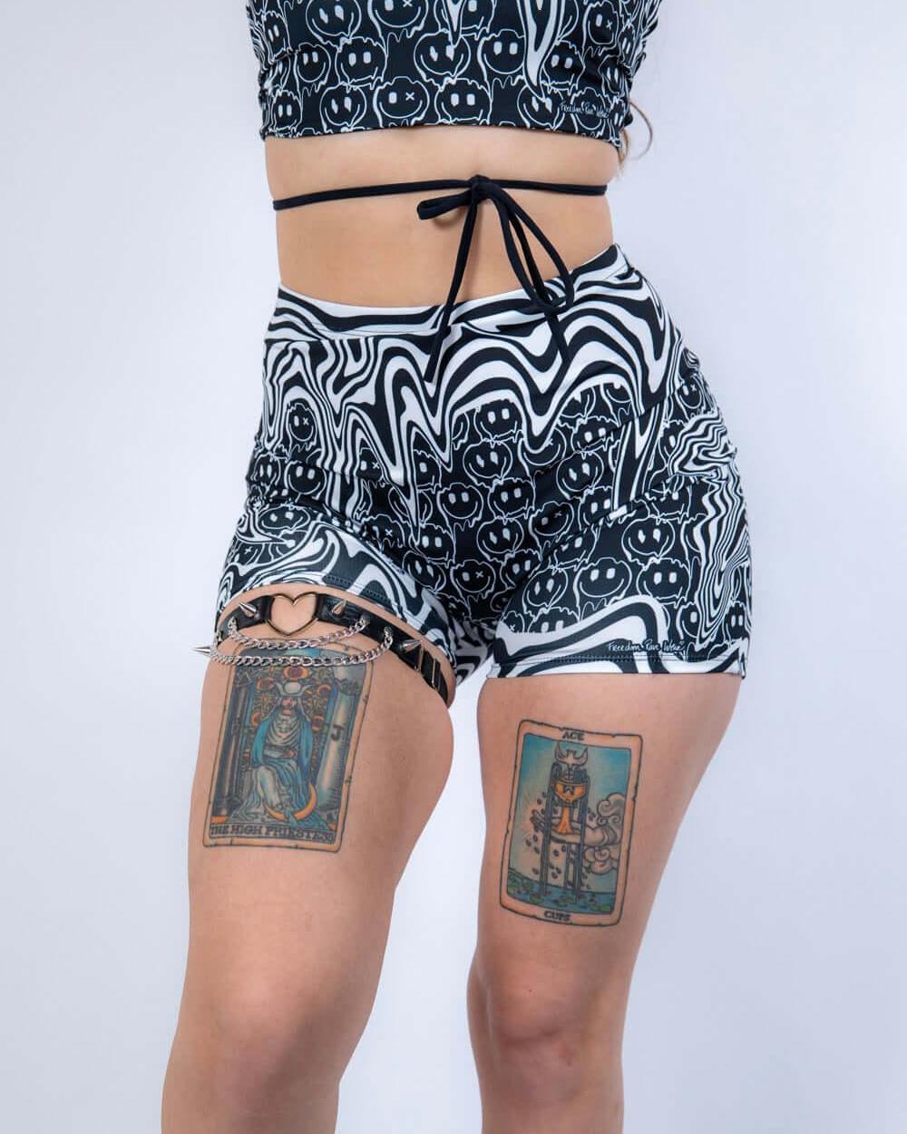 Back view of Meltdown High Waist Shorts, highlighting the flattering high-rise fit and bold trippy smiley pattern.